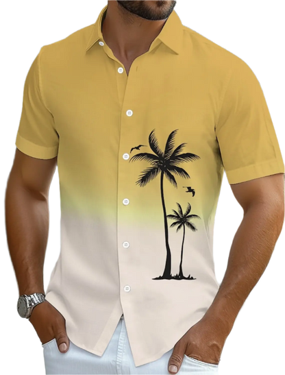 Yellow and beige gradient shirt with palm tree design worn by a person.